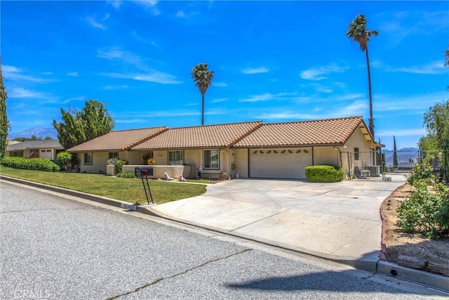 4256 Mockingbird Ln, Banning, CA 92220 - ranch-style home featuring a tile roof, stucco siding, an attached garage, concrete driveway, and a gate
