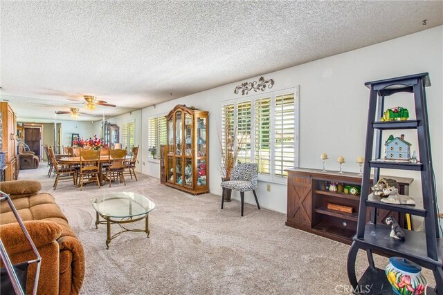 4256 Mockingbird Ln, Banning, CA 92220 - living area with carpet floors, ceiling fan, and a textured ceiling