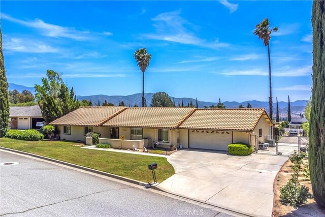 4256 Mockingbird Ln, Banning, CA 92220 - ranch-style house featuring a mountain view, a tile roof, an attached garage, and stucco siding