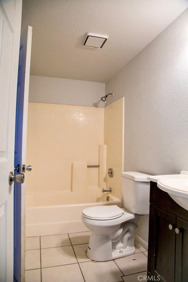 1003 Lightcap St, Lancaster, CA 93535 - bathroom featuring toilet, vanity, tile patterned flooring, tub / shower combination, and a textured wall