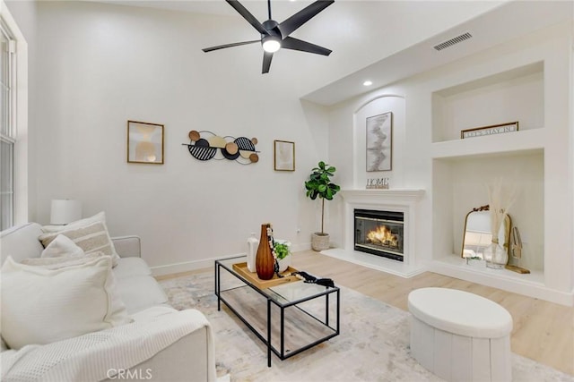 28210 Canterbury Ct, Valencia, CA 91354 - living area featuring wood finished floors, a ceiling fan, a glass covered fireplace, recessed lighting, and baseboards
