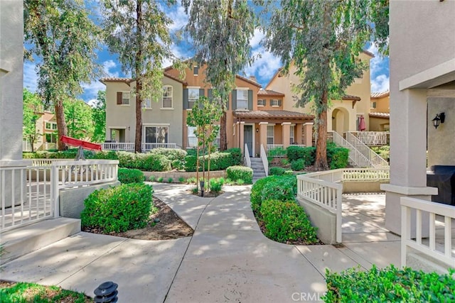 28210 Canterbury Ct, Valencia, CA 91354 - view of front of property featuring a tiled roof, stucco siding, stairway, and a residential view