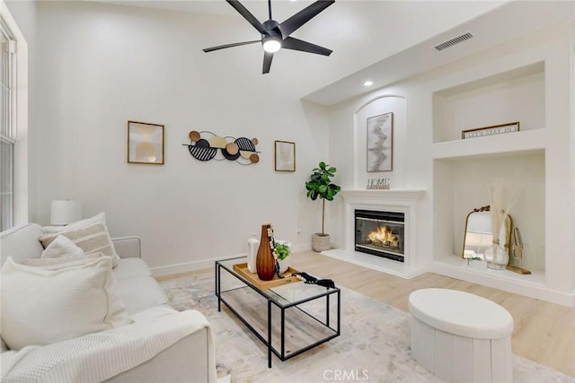 28210 Canterbury Ct, Valencia, CA 91354 - living area featuring wood finished floors, a ceiling fan, a glass covered fireplace, recessed lighting, and baseboards