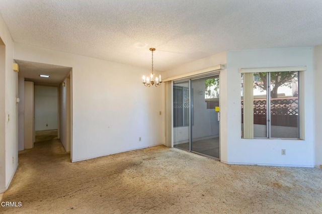1742 Sinaloa Rd Unit 329, Simi Valley, CA 93065 - spare room with carpet, a chandelier, and a textured ceiling