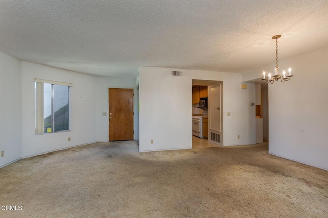 1742 Sinaloa Rd Unit 329, Simi Valley, CA 93065 - empty room featuring a chandelier, light colored carpet, and a textured ceiling
