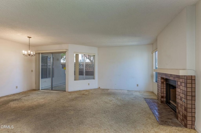1742 Sinaloa Rd Unit 329, Simi Valley, CA 93065 - unfurnished living room with a tile fireplace, plenty of natural light, carpet floors, a chandelier, and a textured ceiling