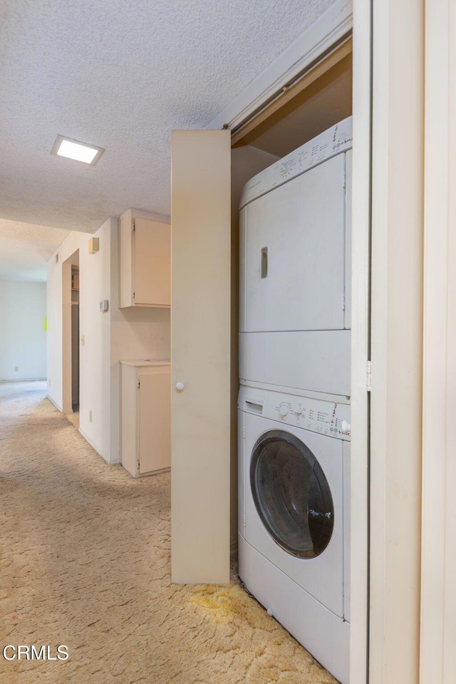 1742 Sinaloa Rd Unit 329, Simi Valley, CA 93065 - washroom featuring estacked washer and dryer, light colored carpet, and a textured ceiling