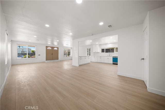 5832 6th Ave, Los Angeles, CA 90043 - unfurnished living room featuring light wood finished floors, recessed lighting, baseboards, and a sink