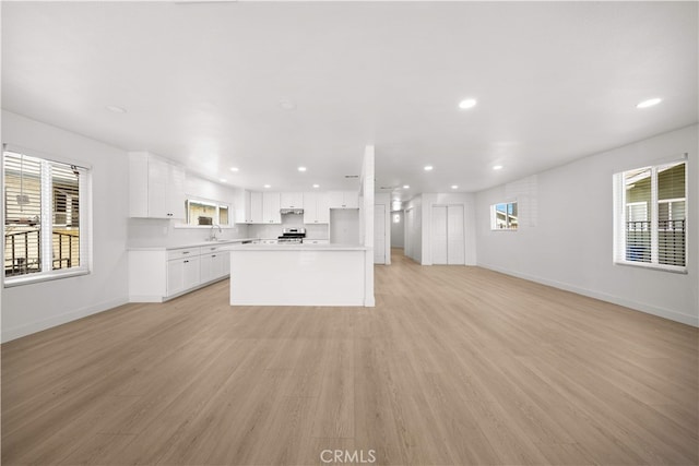5832 6th Ave, Los Angeles, CA 90043 - unfurnished living room with baseboards, recessed lighting, light wood-style floors, and a sink