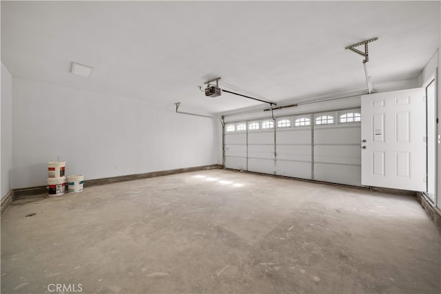 5832 6th Ave, Los Angeles, CA 90043 - garage featuring a garage door opener and baseboards