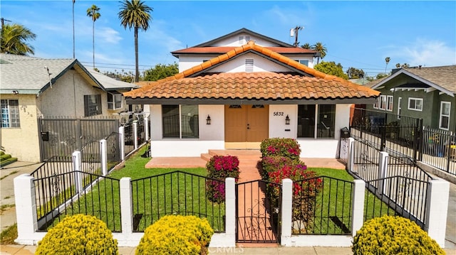 5832 6th Ave, Los Angeles, CA 90043 - bungalow-style home featuring a tiled roof, covered porch, stucco siding, and a gate