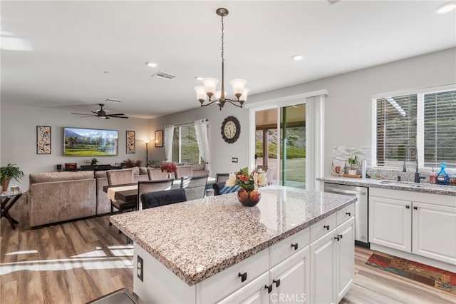 20793 Spring Mountain Rd, Riverside, CA 92507 - kitchen featuring stainless steel dishwasher, a sink, light wood finished floors, open floor plan, and recessed lighting