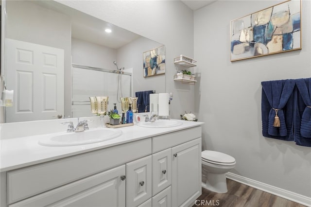 20793 Spring Mountain Rd, Riverside, CA 92507 - bathroom featuring a shower, double vanity, toilet, wood finished floors, and baseboards
