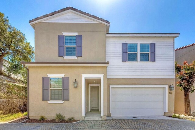 678 Gemstone Dr, San Marcos, CA 92078 - traditional-style house featuring a garage, decorative driveway, and stucco siding