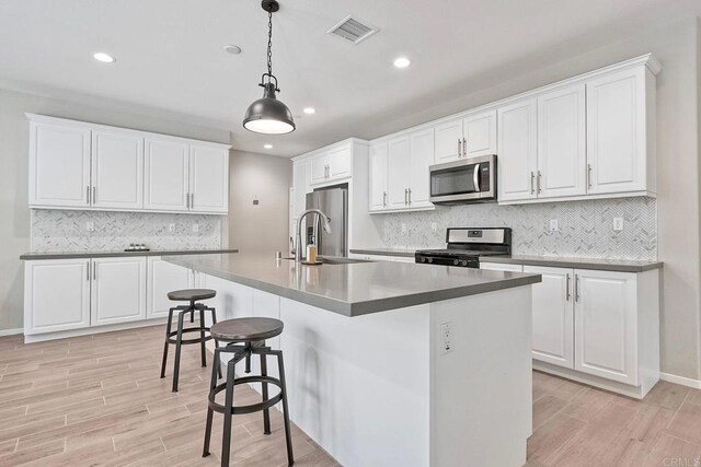 678 Gemstone Dr, San Marcos, CA 92078 - kitchen featuring stainless steel appliances, a sink, light wood-type flooring, recessed lighting, and decorative backsplash