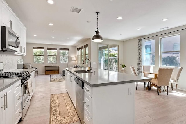 678 Gemstone Dr, San Marcos, CA 92078 - kitchen with a sink, stainless steel appliances, recessed lighting, white cabinetry, and light wood-type flooring