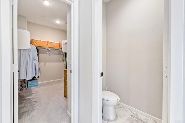 678 Gemstone Dr, San Marcos, CA 92078 - bathroom featuring toilet, baseboards, and a walk in closet