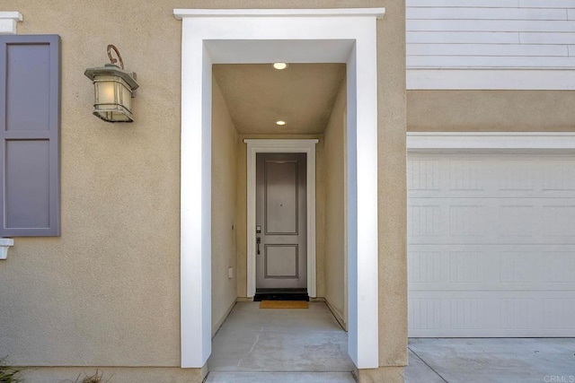 678 Gemstone Dr, San Marcos, CA 92078 - view of exterior entry featuring stucco siding and a garage