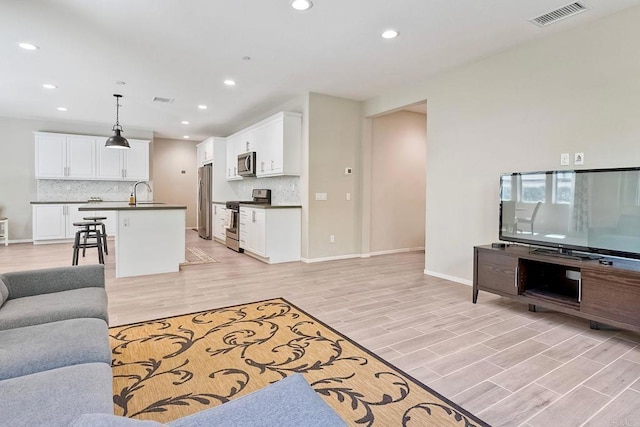 678 Gemstone Dr, San Marcos, CA 92078 - living room featuring light wood-style floors, recessed lighting, and baseboards