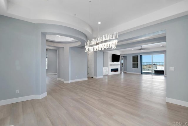 1733 Lemonadeberry Ln, Vista, CA 92084 - unfurnished living room featuring a fireplace, baseboards, light wood-style floors, and ceiling fan