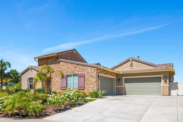 1733 Lemonadeberry Ln, Vista, CA 92084 - ranch-style house with a garage, driveway, stucco siding, and stone siding