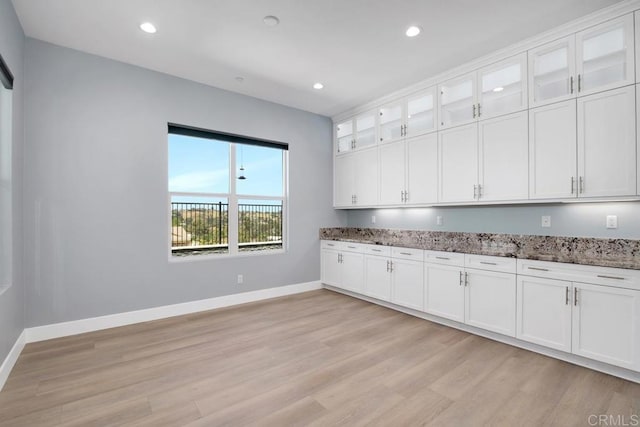 1733 Lemonadeberry Ln, Vista, CA 92084 - kitchen with stone counters, light wood-style flooring, white cabinets, recessed lighting, and glass insert cabinets
