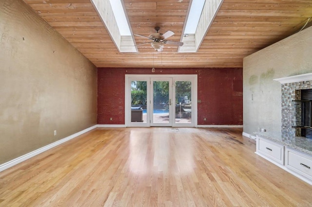 1575 Larson Ln, Fallbrook, CA 92028 - unfurnished living room featuring wood ceiling, a skylight, light wood-style flooring, baseboards, and a fireplace