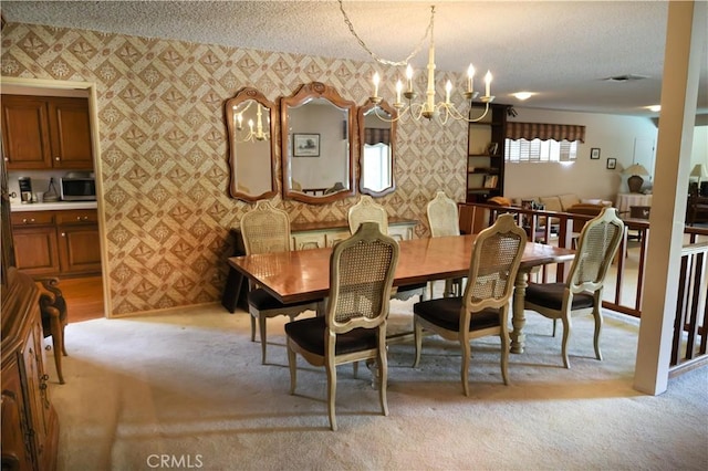 10035 Gierson Ave, Chatsworth, CA 91311 - dining space featuring wallpapered walls, a textured ceiling, a chandelier, and light colored carpet