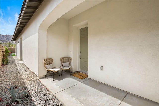 56217 Platinum Way, La Quinta, CA 92253 - doorway to property with stucco siding and a mountain view