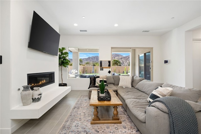 56217 Platinum Way, La Quinta, CA 92253 - tiled living room featuring a glass covered fireplace and recessed lighting