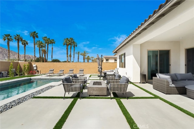 56217 Platinum Way, La Quinta, CA 92253 - fenced backyard featuring an outdoor living space with a fire pit, a patio area, and a mountain view