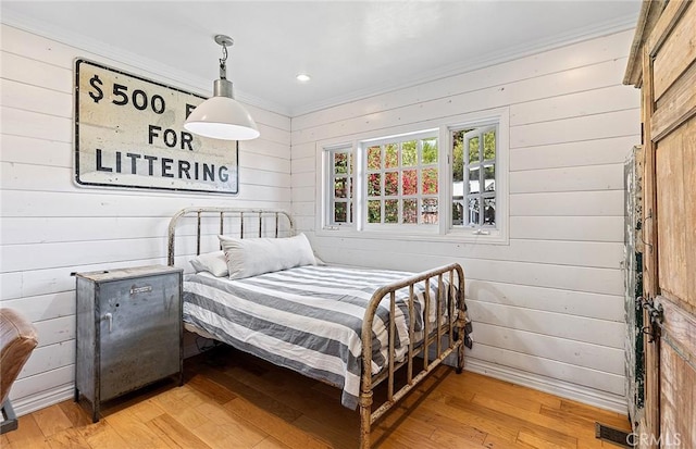 230 Esplanade, San Clemente, CA 92672 - bedroom featuring crown molding, wood walls, and light wood finished floors