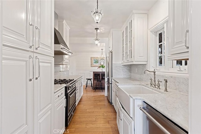 230 Esplanade, San Clemente, CA 92672 - kitchen featuring appliances with stainless steel finishes, white cabinets, light wood-style flooring, and backsplash
