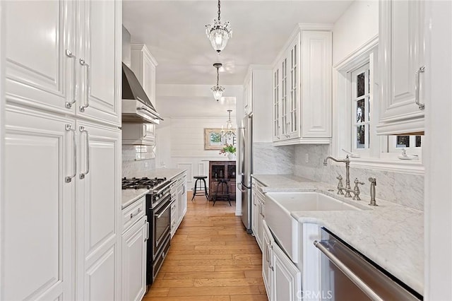 230 Esplanade, San Clemente, CA 92672 - kitchen with appliances with stainless steel finishes, white cabinetry, decorative backsplash, and light wood-type flooring