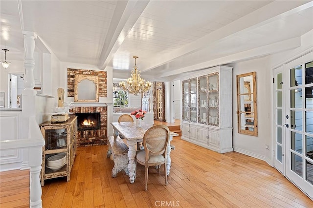 230 Esplanade, San Clemente, CA 92672 - dining room with a chandelier, light wood-style floors, and a fireplace