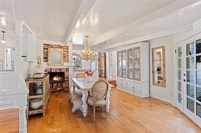 230 Esplanade, San Clemente, CA 92672 - dining space featuring a chandelier, light wood finished floors, and a fireplace
