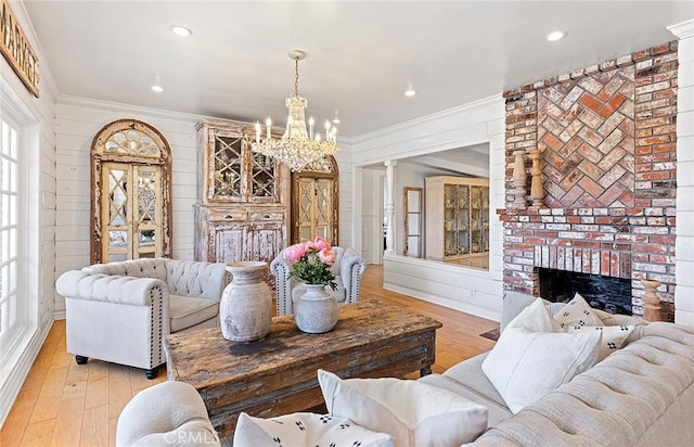 230 Esplanade, San Clemente, CA 92672 - living room featuring crown molding, a chandelier, light wood-type flooring, a fireplace, and recessed lighting