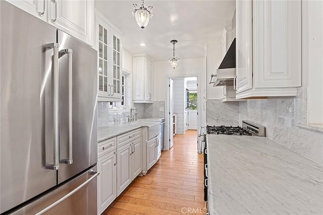 230 Esplanade, San Clemente, CA 92672 - kitchen with appliances with stainless steel finishes, exhaust hood, white cabinetry, glass insert cabinets, and recessed lighting