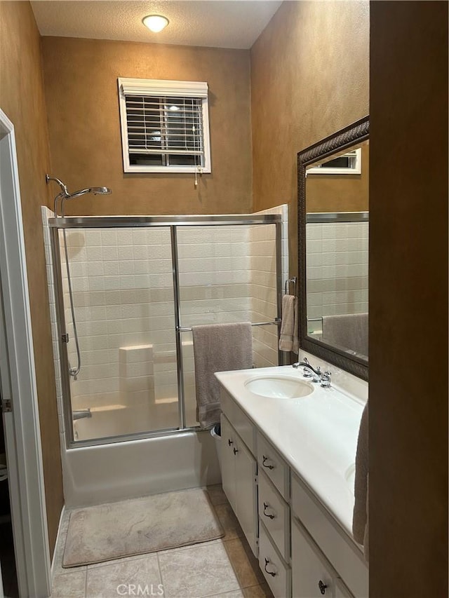 27951 Via De Costa, San Juan Capistrano, CA 92675 - full bathroom with vanity, bath / shower combo with glass door, tile patterned floors, and a textured wall