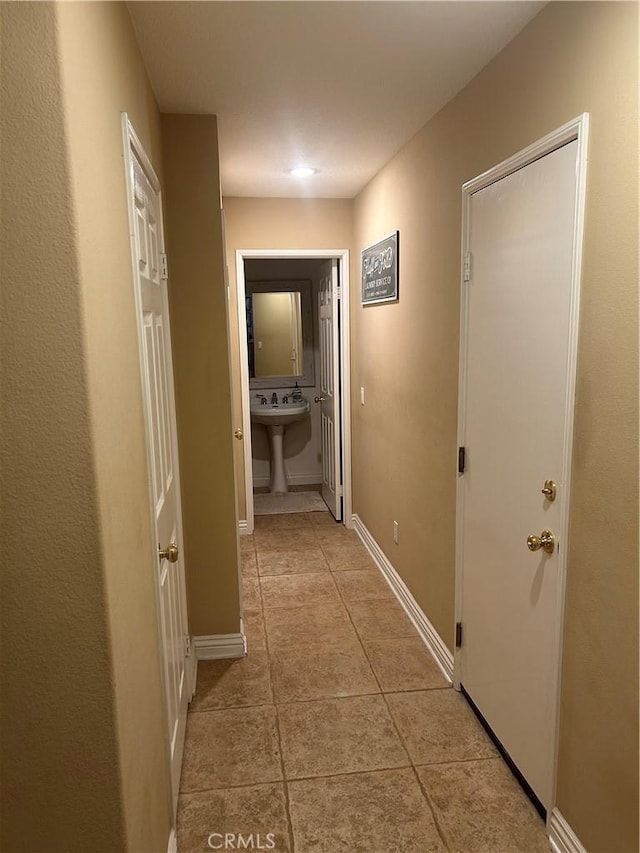 27951 Via De Costa, San Juan Capistrano, CA 92675 - hallway featuring baseboards, a sink, and light tile patterned floors