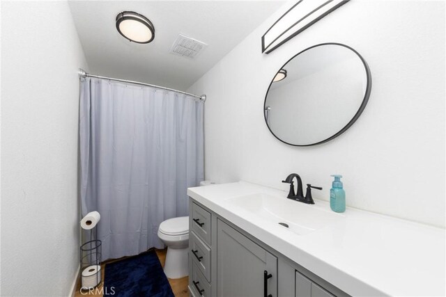 38448 95th St E, Palmdale, CA 93591 - full bath featuring vanity, toilet, a shower with curtain, and wood finished floors