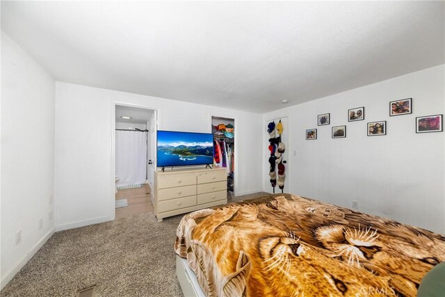 38448 95th St E, Palmdale, CA 93591 - bedroom featuring carpet, a closet, baseboards, and ensuite bath