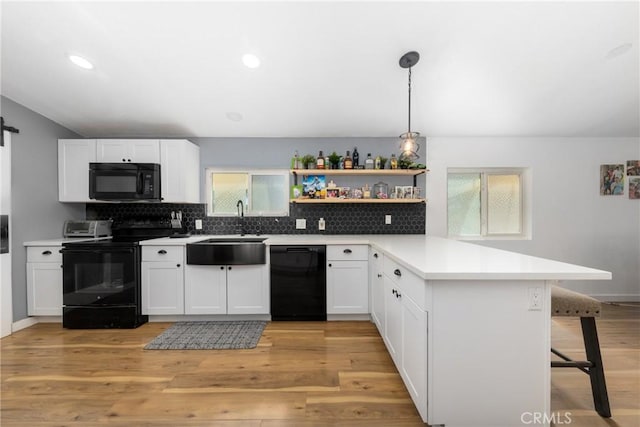 38448 95th St E, Palmdale, CA 93591 - kitchen featuring black appliances, a sink, a peninsula, open shelves, and backsplash