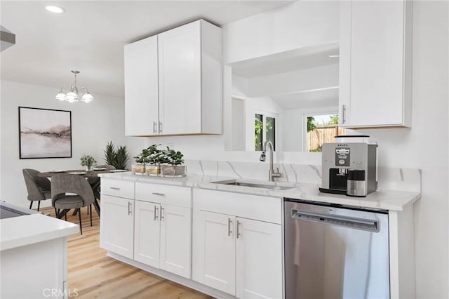 28870 Crosby Dr, Menifee, CA 92586 - kitchen featuring dishwasher, a sink, a chandelier, white cabinets, and light stone counters
