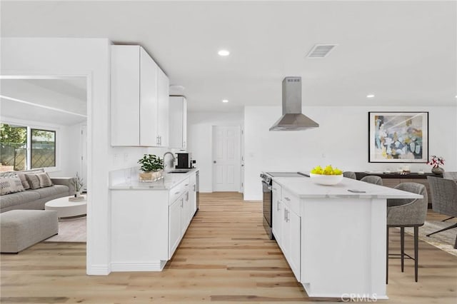28870 Crosby Dr, Menifee, CA 92586 - kitchen featuring island range hood, open floor plan, a sink, a breakfast bar, and recessed lighting