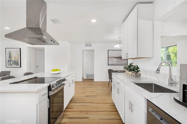 28870 Crosby Dr, Menifee, CA 92586 - kitchen featuring range hood, stainless steel appliances, a sink, white cabinetry, and recessed lighting