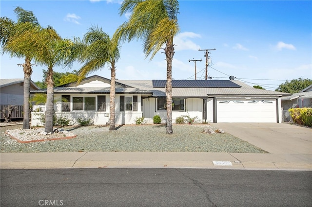 28870 Crosby Dr, Menifee, CA 92586 - single story home with a garage, concrete driveway, roof mounted solar panels, and board and batten siding