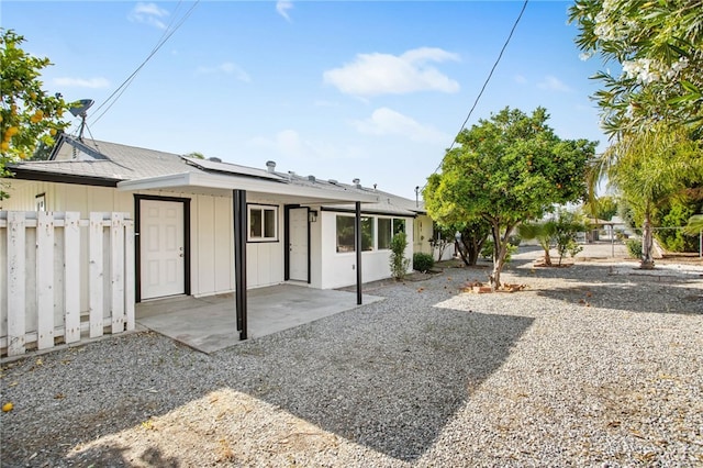 28870 Crosby Dr, Menifee, CA 92586 - back of property featuring roof mounted solar panels, a patio, and board and batten siding