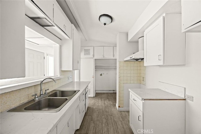 2517 S 2nd Ave, Arcadia, CA 91006 - kitchen with a sink, white cabinetry, wood finished floors, decorative backsplash, and wall chimney exhaust hood