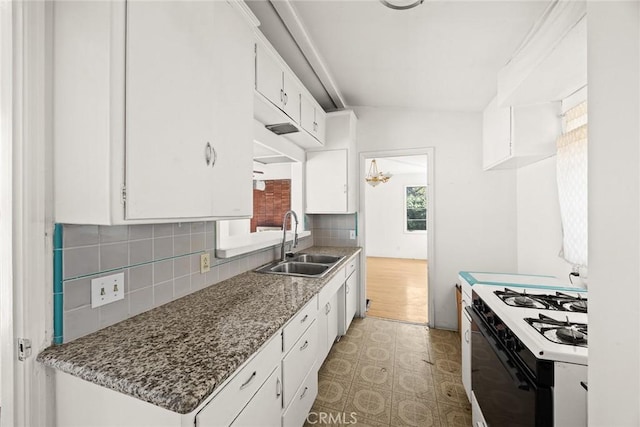 2517 S 2nd Ave, Arcadia, CA 91006 - kitchen with white gas stove, a sink, light floors, backsplash, and white cabinets